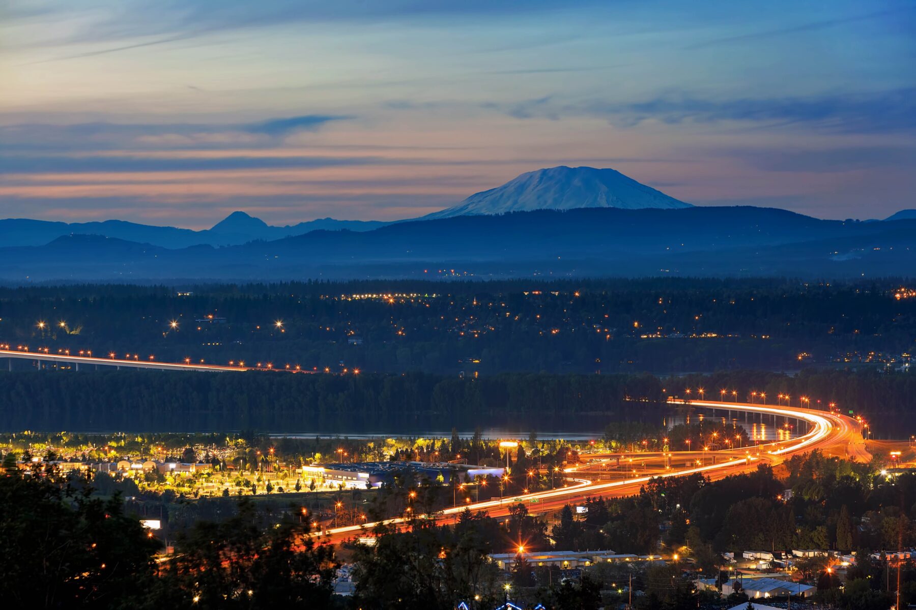 nighttime view of a beautiful city line and mountains