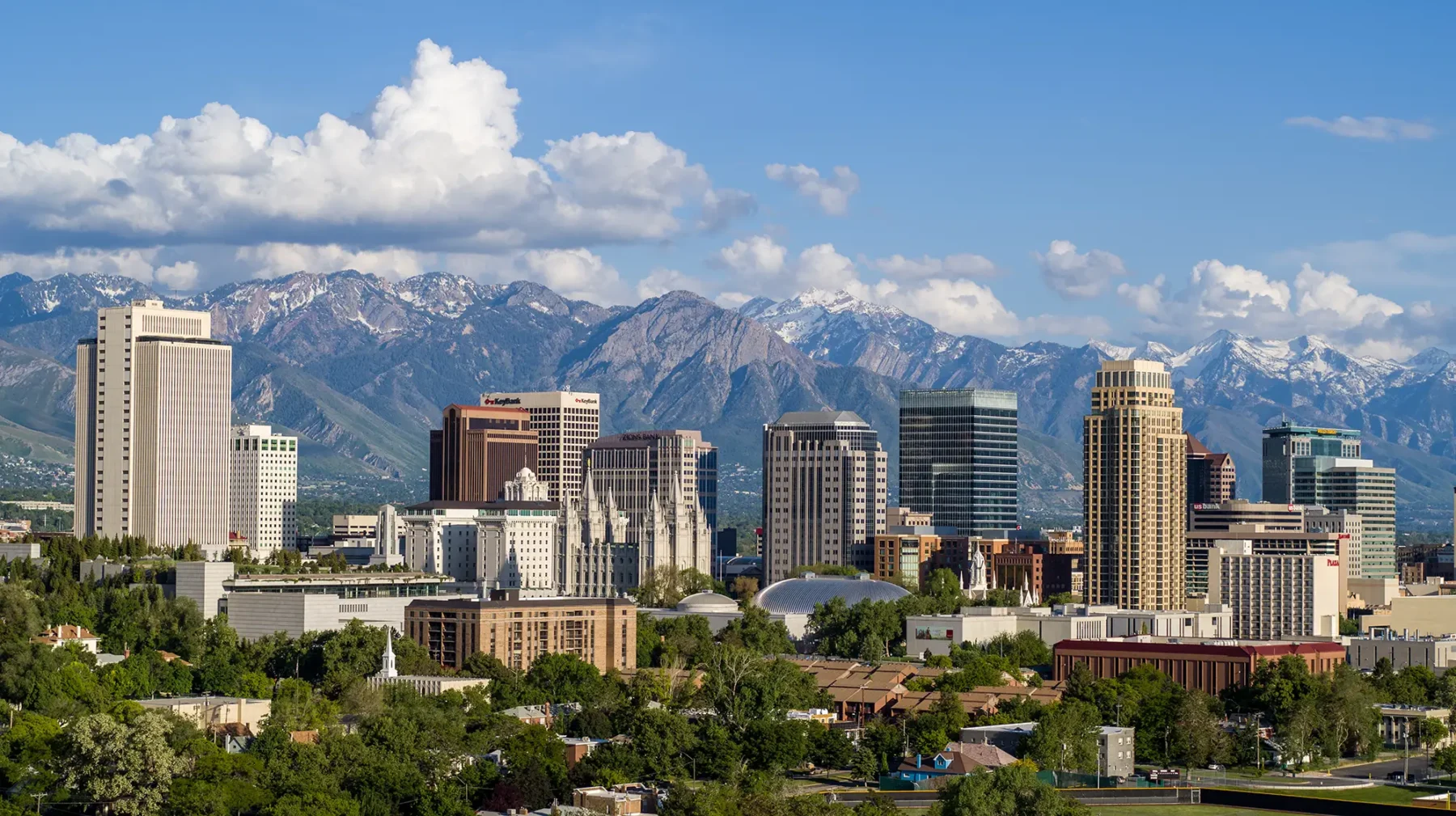Aerial view of Salt lake city skyline with tall buildings and mountains in the distance