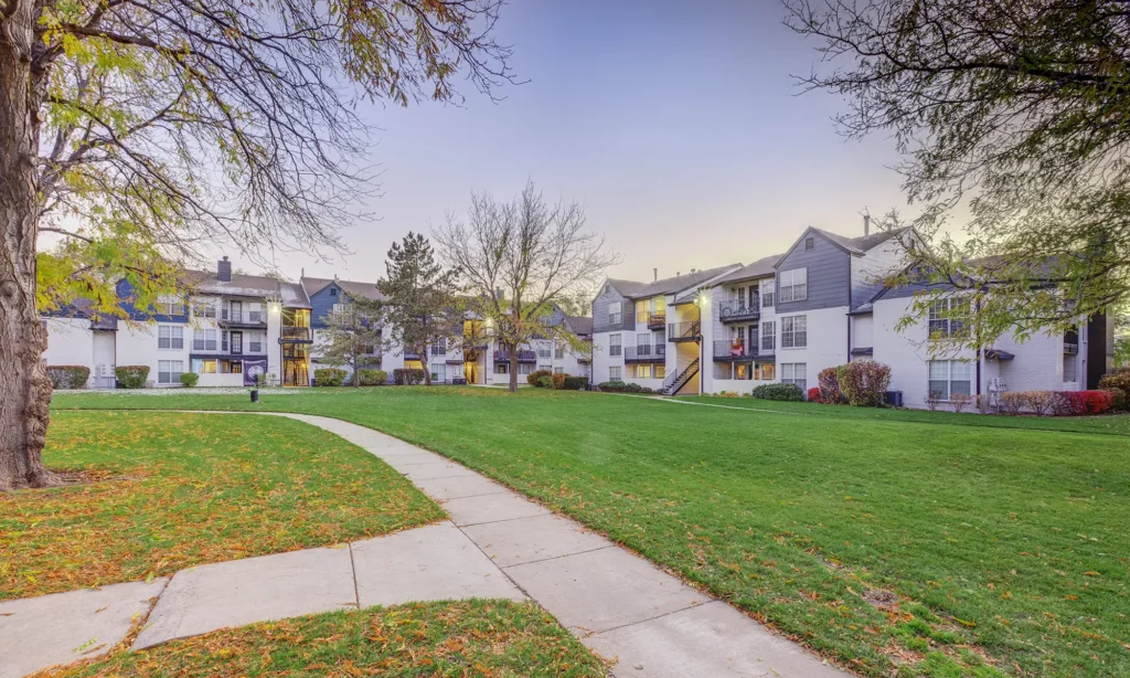 Green space between buildings with tree lined paths