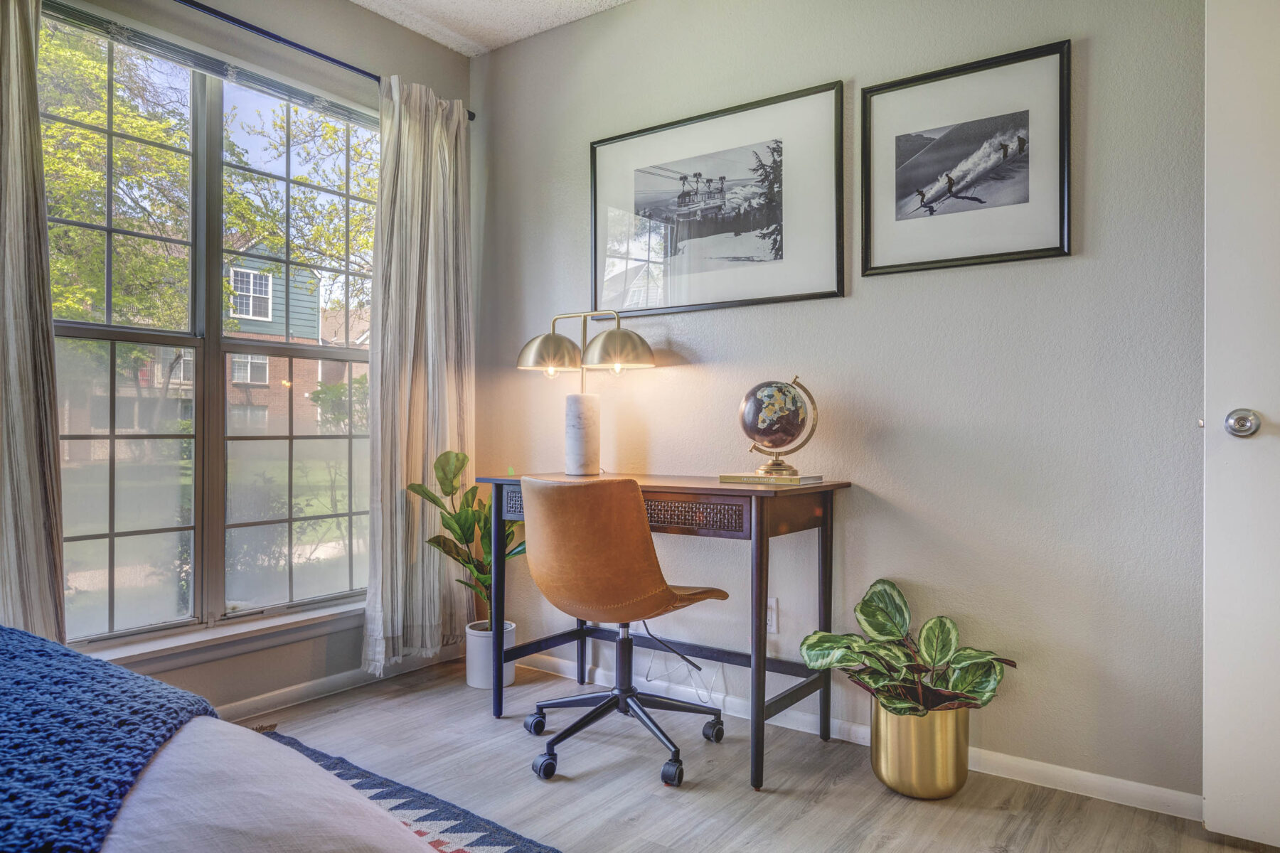 Small staged desk in the bedroom next to a window